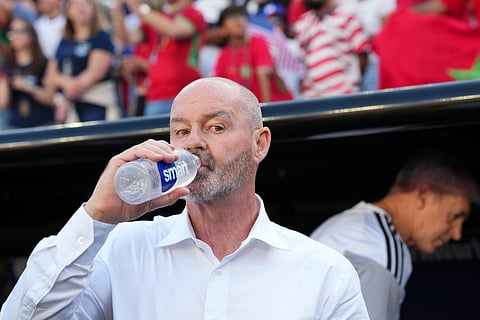 Scotland head coach Steve Clarke drinks water prior to the World Cup Group C soccer match between Scotland and Morocco in Foxborough, Mass., near Boston, Friday, June 19, 2026.