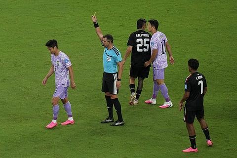 South Korea's Paik Seung-ho, left, reacts as referee Gustavo Tejera, of Uruguay, holds up a yellow card during the World Cup Group A soccer match between Mexico and South Korea in Zapopan, near Guadalajara, Mexico, Thursday, June 18, 2026.