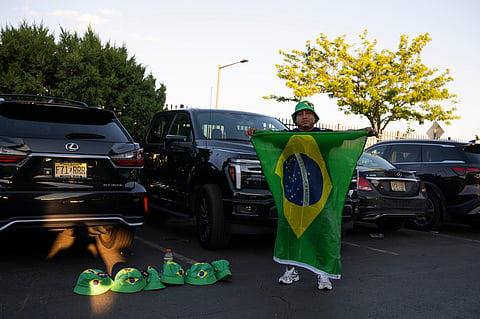 A vendor hawks Brazilian-themed hats and banners as fans gather for a watch party for the Haiti and Brazil World Cup match, at Lincoln Financial Field in Philadelphia, Friday, June 19, 2026.