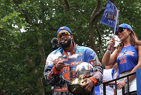 New York Knicks player Karl-Anthony Towns celebrates the team's NBA championship during a ticker-tape parade down Lower Manhattan's "Canyon of Heroes" on Broadway, in New York. 