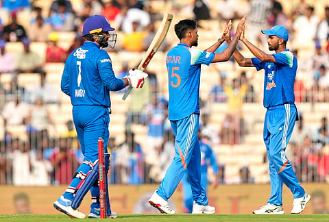 India's Gurnoor Brar, center, celebrates with teammate Washington Sundar the wicket of Afghanistan's Mohammad Nabi, left, during the third ODI cricket match between Afghanistan and India in Chennai.
