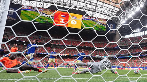 Netherlands' Brian Brobbey, left, scores their second goal past Sweden goalkeeper Kristoffer Nordfeldt (23)
