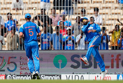 India's Rohit Sharma, right, throws the ball after fielding a shot during the third ODI cricket match between Afghanistan and India in Chennai.