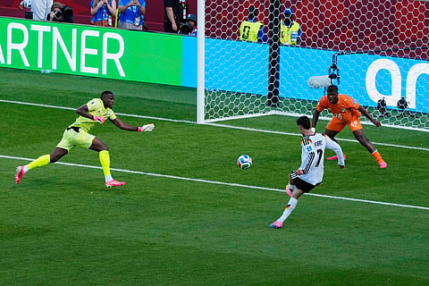 Germany's Kai Havertz (7) scores a goal, that would be disallowed, as Ivory Coast goalkeeper Yahia Fofana 