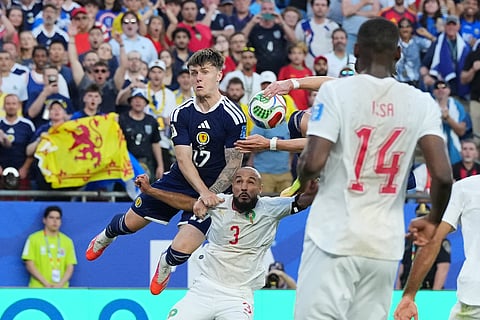 Scotland's Ben Gannon-Doak, top, jumps over Morocco's Noussair Mazraoui (3) during the World Cup Group C soccer match between Scotland and Morocco in Foxborough, Mass., near Boston, Friday, June 19, 2026.