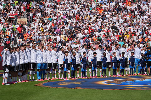 The German team line up as the national anthems are played during the World Cup Group E soccer match 