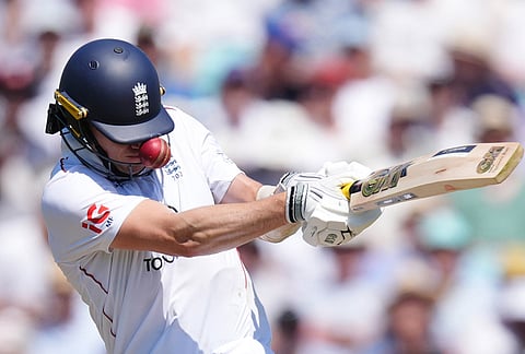 England's Matt Fisher is hit by a bouncer from New Zealand's Will O'Rourke on day three of the second cricket test between England and New Zealand, in London.