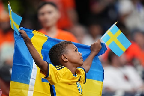 A fan of Sweden waits for the start of the World Cup Group F soccer match between the Netherlands and Sweden in Houston