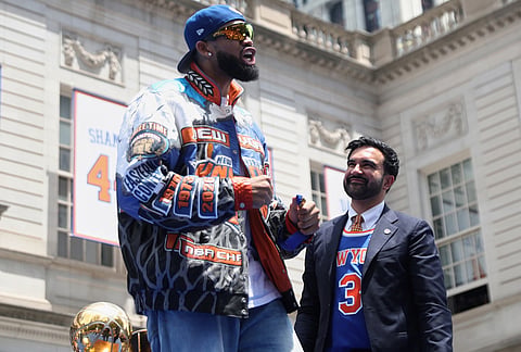 New York Knicks center Karl-Anthony Towns celebrates during the New York Knicks' NBA championship parade in New York. 