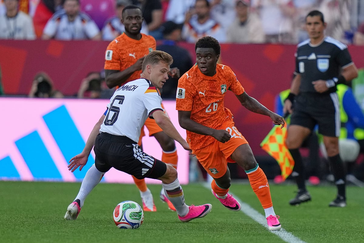 Germany's Joshua Kimmich, left, vies for the ball with Ivory Coast's Christ Inao Oulai during the World Cup Group E soccer match - AP/Stephanie Scarbrough