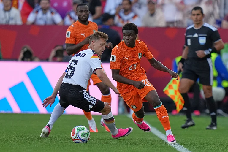 Germany's Joshua Kimmich, left, vies for the ball with Ivory Coast's Christ Inao Oulai during the World Cup Group E soccer match - AP/Stephanie Scarbrough