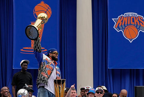 New York Knicks center Karl-Anthony Towns celebrates during the New York Knicks' NBA championship parade in New York. 
