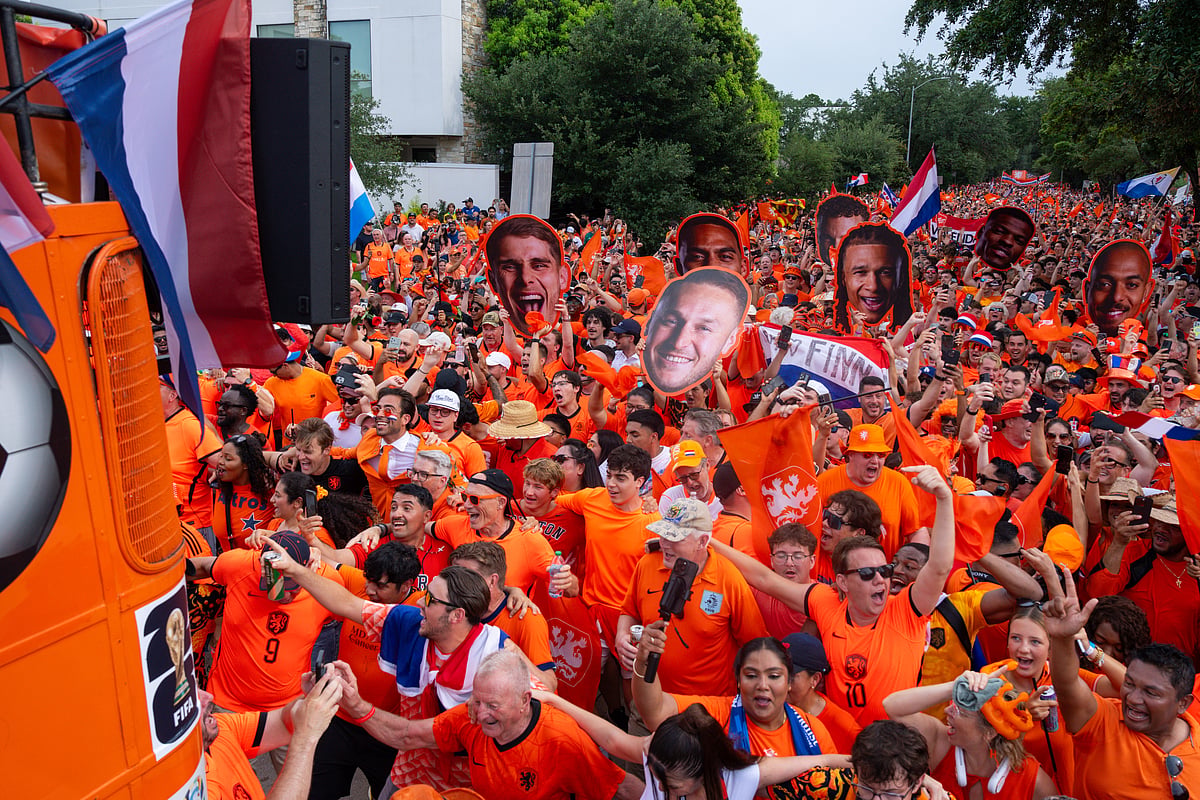 Netherlands fans take part in an "Orange Walk" to Houston Stadium before a FIFA World Cup Group F soccer match between Netherlands and Sweden in Houston. - AP/Jon Shapley