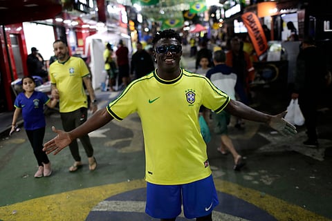 A man dressed as Brazilian soccer player Vinicius Junior arrives to watch Brazil's World Cup match against Haiti at the Rocinha favela in Rio de Janeiro, Brazil, Friday, June 19, 2026.