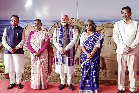 President Droupadi Murmu and Prime Minister Narendra Modi in a photograph with Odisha Governor Hari Babu Kambhampati, state Chief Minister Mohan Charan Majhi and others during a visit to the Skill Centre and School, at Pahadpur village, in Mayurbhanj district, Odisha. 