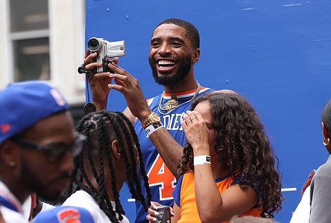 New York Knicks player Mikal Bridges celebrates the team's NBA championship during a ticker-tape parade down Lower Manhattan's "Canyon of Heroes" on Broadway in New York. This was the Knicks' first NBA championship in 53 years. 

