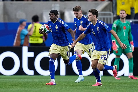 Sweden's Anthony Elanga celebrates after scoring their first goal during the World Cup Group F soccer match between the Netherlands and Sweden in Houston