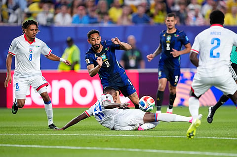 Brazil's Matheus Cunha (9) is tackled by Haiti's Danley Jean Jacques (17) during the World Cup Group C soccer match between Brazil and Haiti in Philadelphia, Friday, June 19, 2026.