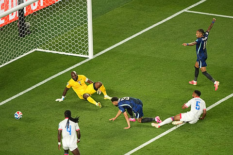 Brazil's Matheus Cunha (9) scores their opening goal against Haiti goalkeeper Johny Placide (1) during the World Cup Group C soccer match between Brazil and Haiti in Philadelphia, Friday, June 19, 2026.
