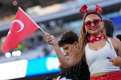 A female Turkish supporter cheers for her team before the start of the World Cup Group D soccer match between Turkey and Paraguay in Santa Clara, Calif., near San Francisco, Friday, June 19, 2026