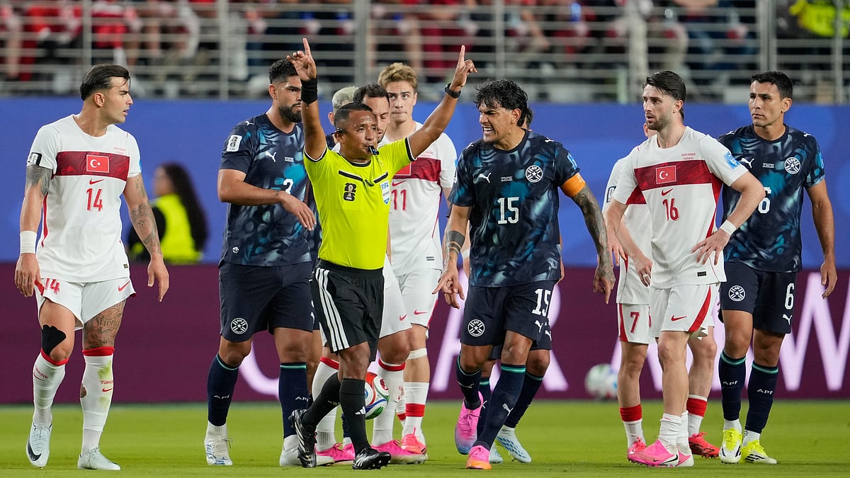 Referee Ivan Arcides Barton Cisneros, of El Salvador, signals to ask for a VAR review before issuing a red card to Paraguay's Miguel Almiron (10) during the World Cup Group D soccer match between Turkey and Paraguay in Santa Clara, Calif., near San Francisco, Friday, June 19, 2026 - (AP Photo/Eugene Hoshiko)