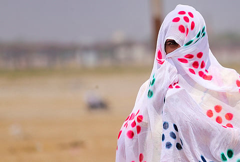A man covers himself on a summer day near the Sangam, in Prayagraj, Uttar Pradesh.