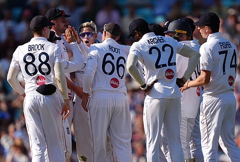 England's Jacob Bethell, fourth left, celebrates with team-mates after taking the wicket of New Zealand's Rachin Ravindra lbw on day three of the second cricket test between England and New Zealand, in London.