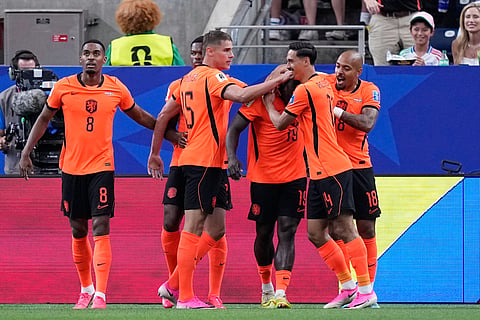 Netherlands' Brian Brobbey, 3rd right, celebrates after scoring the opening goal during the World Cup Group F soccer match