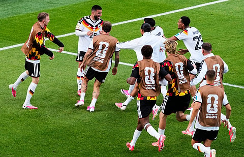 Germany's Deniz Undav (26) is mobbed by teammates after scoring their second goal during the World Cup Group E soccer match