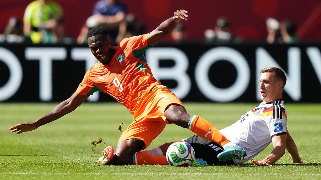 Ivory Coast's Ange-Yoan Bonny (9) is tackled by Germany's Nico Schlotterbeck (15) during the World Cup Group E soccer match between Germany and Ivory Coast in Toronto. - Nathan Dennette/The Canadian Press via AP