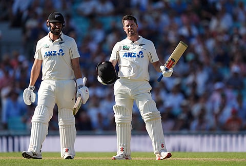 New Zealand's Henry Nicholls, right, celebrates reaching his century on day three of the second cricket test between England and New Zealand, in London.