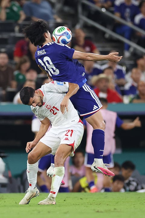 Japan's Ayase Ueda (18) controls the ball with his chest over Tunisia's Mohamed Amine Ben Hmida (21) during the World Cup Group F soccer match between Tunisia and Japan in Guadalupe, near Monterrey, Mexico, Saturday, June 20, 2026.