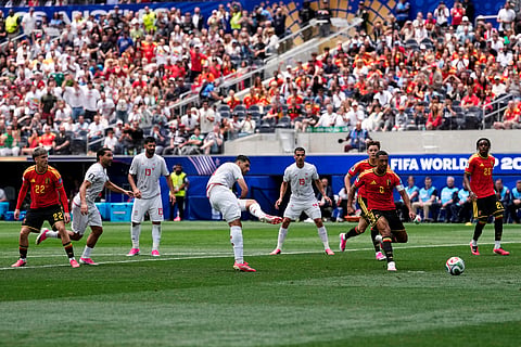 Iran's Mehdi Taremi (9), center, scores a disallowed goal during the World Cup Group G soccer match between Belgium and Iran..