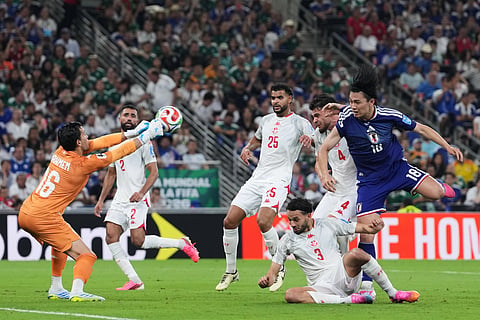 Tunisia goalkeeper Aymen Dahmen blocks an attack by Japan's Ayase Ueda (18) during the World Cup Group F soccer match in Guadalupe, near Monterrey, Mexico, Saturday, June 20, 2026.