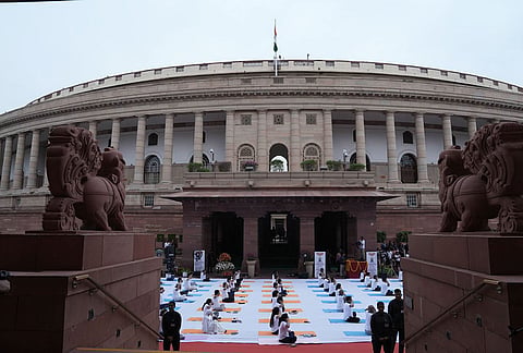 Participants perform yoga during a session on the occasion of the International Day of Yoga at the Parliament House complex, in New Delhi.