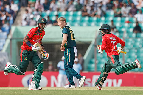 Bangladesh's captain Towhid Hridoy, right, and Shoriful Islam run between the wickets to score during the third T20 international cricket match between Australia and Bangladesh, in Chattogram, Bangladesh.