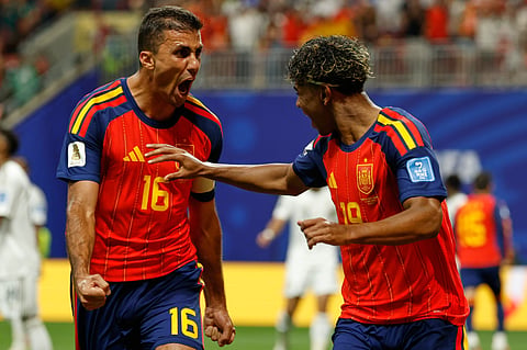 Spain's Lamine Yamal celebrates with teammate Rodri,