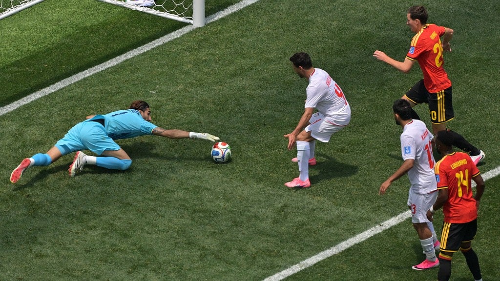 Iran goalkeeper Alireza Beiranvand (1) saves during the World Cup Group G soccer match between Belgium and Iran in Inglewood, Calif. - Jayne Kamin-Oncea/AP Photo