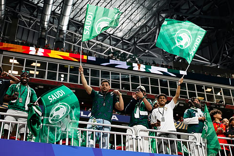 Saudi Arabia fans wave flags in the stands ahead of the World Cup Group H soccer match between Spain and Saudi Arabia.