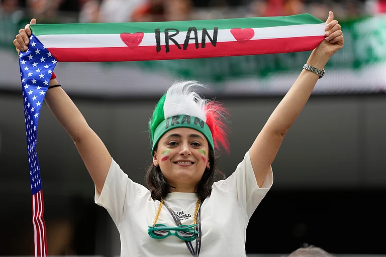 A fan of Iran holds up a scarf prior to the World Cup Group G soccer match between Belgium and Iran in Inglewood, Calif. - AP/Andre Penner