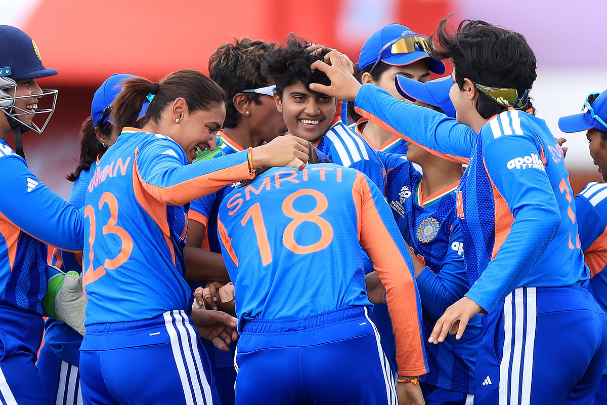 India's Shree Charani celebrates bowling and catching out South Africa's Laura Wolvaardt during the ICC Women's T20 World Cup match between India and South Africa, at Emirates Old Trafford, Manchester - Nigel French/PA via AP