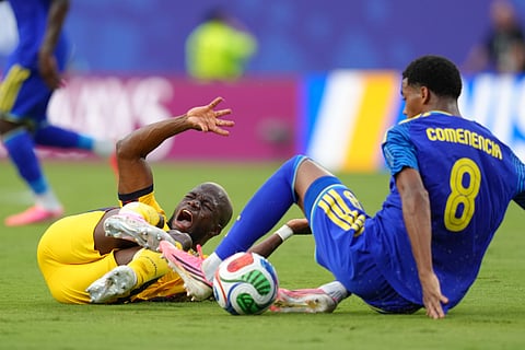 Ecuador's Enner Valencia, left and Curaçao's Livano Comenencia fall during a World Cup Group E soccer match in Kansas City, Mo., Saturday, June 20, 2026.