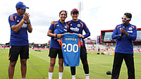 X/BCCI :  Vice-captain Smriti Mandhana and Head Coach Amol Muzumdar present Harmanpreet Kaur with a special '200' jersey & cap signed by the entire squad before her 200th match.