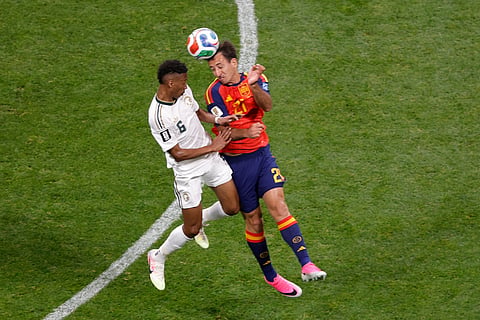 Spain's Mikel Oyarzabal, right, heads a ball next to Saudi Arabia's Nasser Aldawsari.