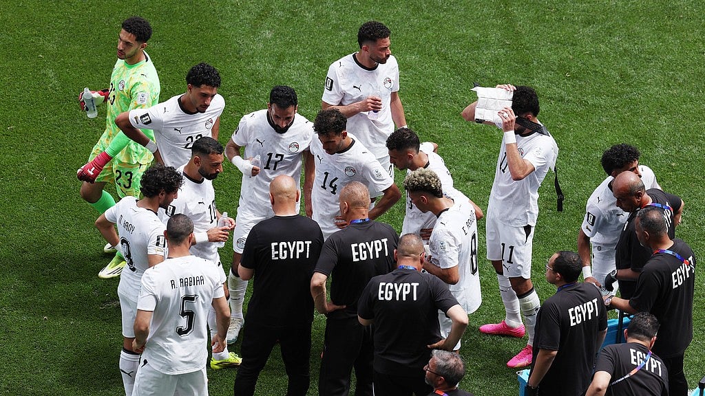 Egypt head coach Hossam Hassan talks with players during the second half hydration break during the World Cup Group G soccer match between Belgium and Egypt in Seattle. - Maddy Grassy/AP Photo