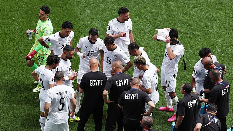 Egypt head coach Hossam Hassan talks with players during the second half hydration break during the World Cup Group G soccer match between Belgium and Egypt in Seattle. - Maddy Grassy/AP Photo