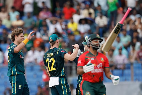 Australia's Spencer Johnson, left, celebrates with teammates the wicket of Bangladesh's Shamim Hossain Paatwary, right, during the third T20 international cricket match between Australia and Bangladesh, in Chattogram, Bangladesh.