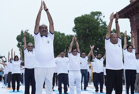 Lok Sabha Speaker Om Birla performs yoga during a session on the occasion of the International Day of Yoga at the Parliament House complex, in New Delhi.