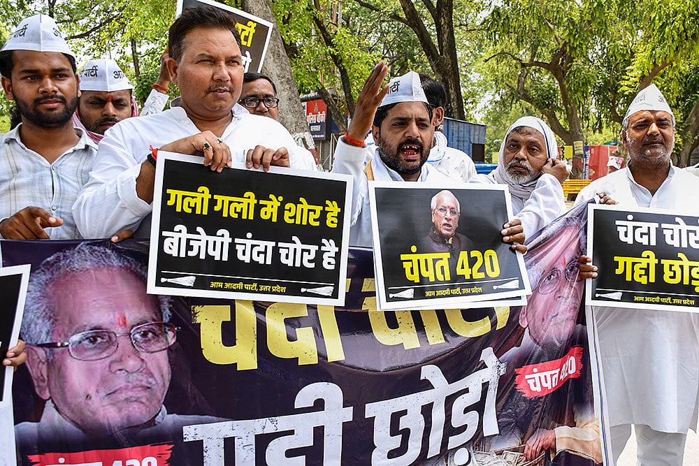 Aam Aadmi Party (AAP) workers hold placards and raise slogans during a protest against Shri Ram Janmabhoomi Teerth Kshetra General Secretary Champat Rai over alleged irregularities in Ram Temple donations, in Prayagraj, Uttar Pradesh,. - | Photo: PTI 