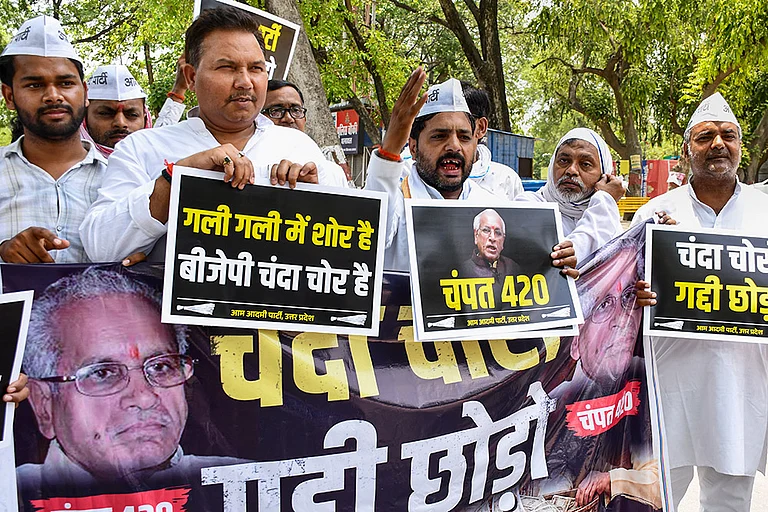 Aam Aadmi Party (AAP) workers hold placards and raise slogans during a protest against Shri Ram Janmabhoomi Teerth Kshetra General Secretary Champat Rai over alleged irregularities in Ram Temple donations, in Prayagraj, Uttar Pradesh,. - | Photo: PTI